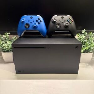 Microsoft Console with Black and Blue Controllers